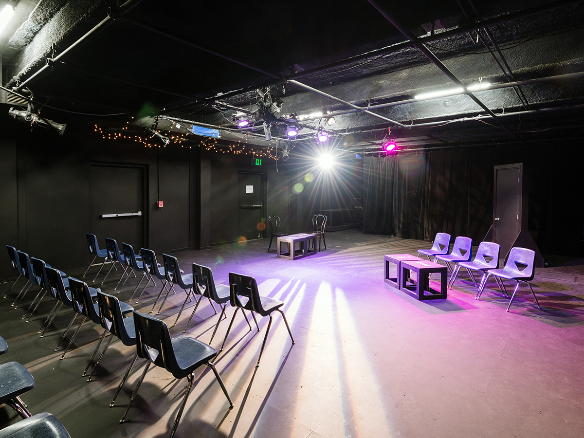 A black box acting classroom with chairs
